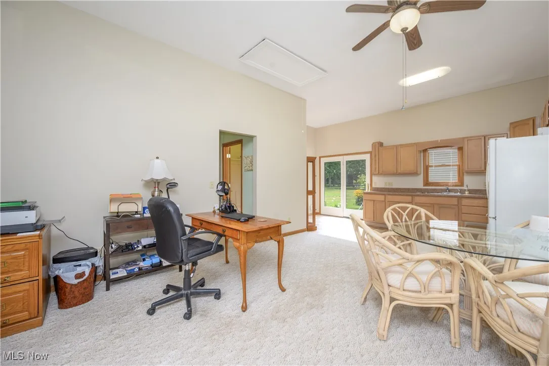Office featuring light carpet and a ceiling fan