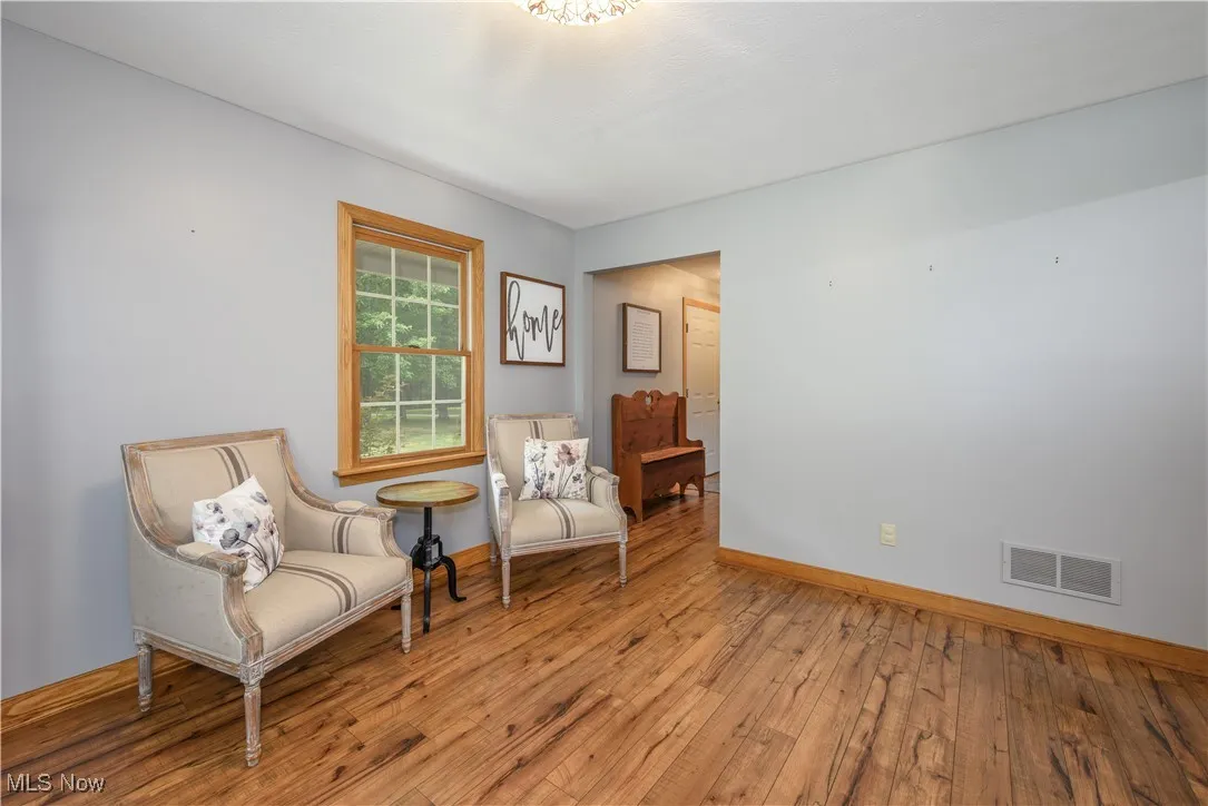 Living area with light wood-style floors and baseboards