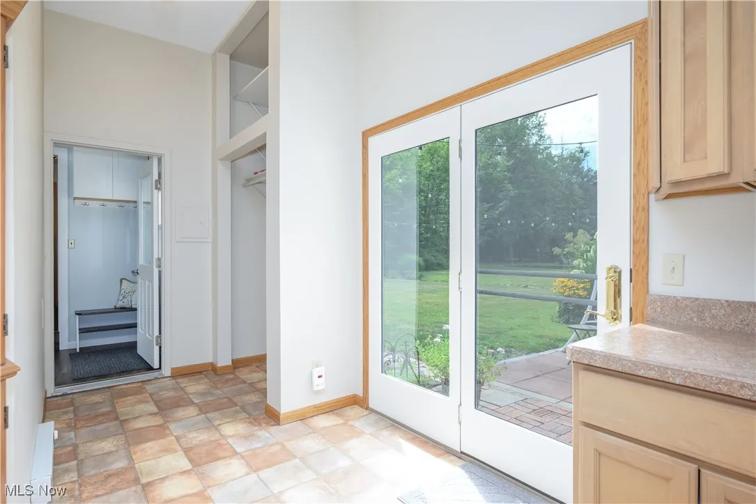 Doorway to outside featuring baseboards