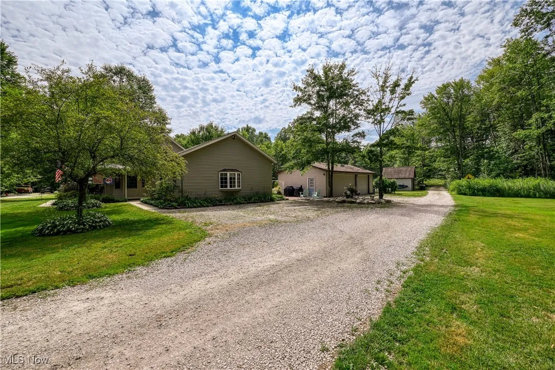 View of front of home featuring driveway and a front lawn