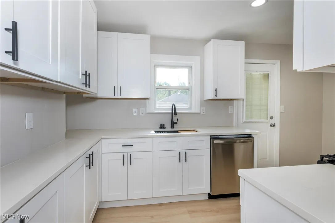 Kitchen with dishwasher, white cabinetry, light wood-style flooring, light countertops, and recessed lighting