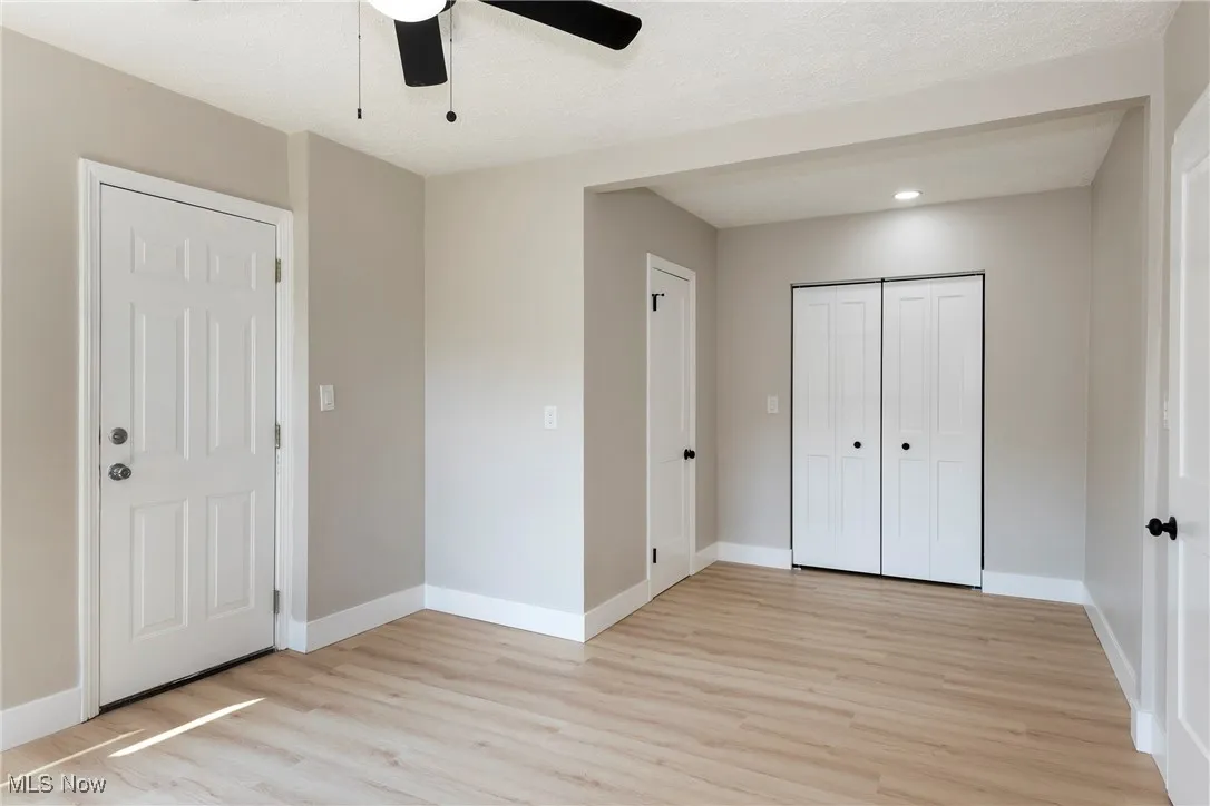 Unfurnished bedroom with light wood-style floors, recessed lighting, a closet, and ceiling fan