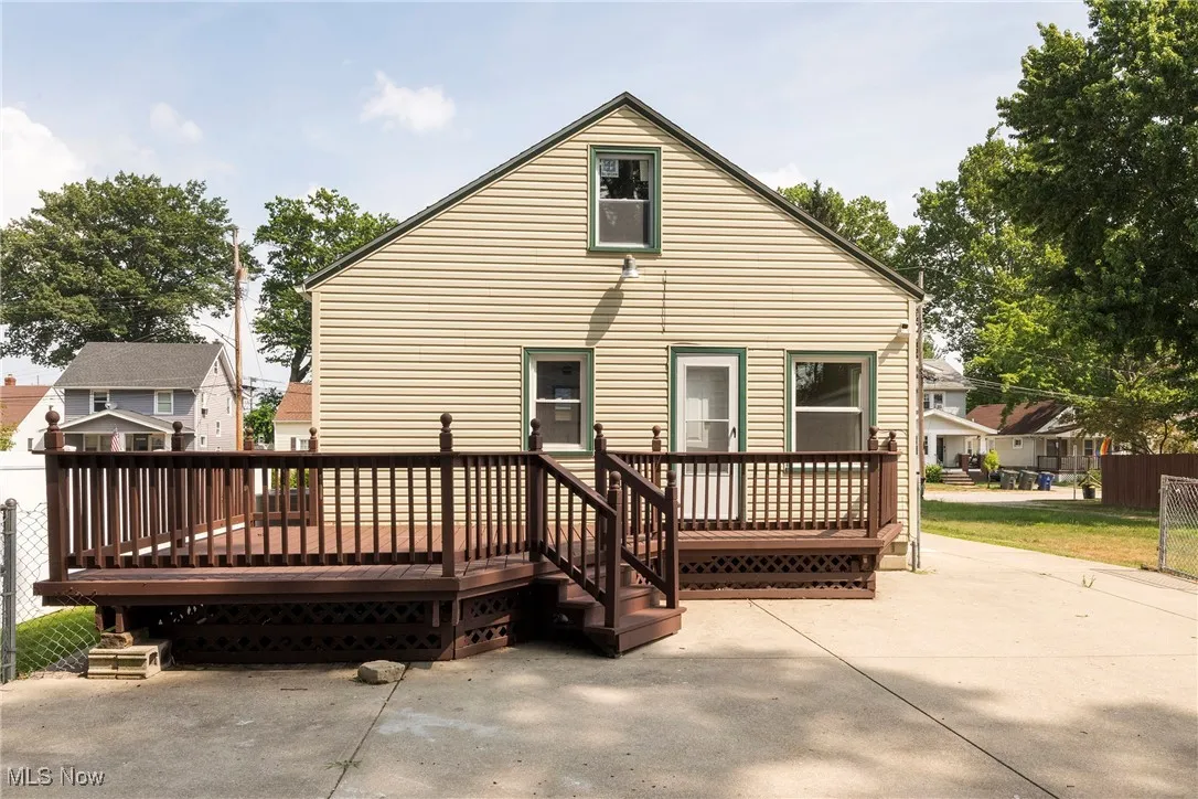 Back of house featuring a deck and a patio area