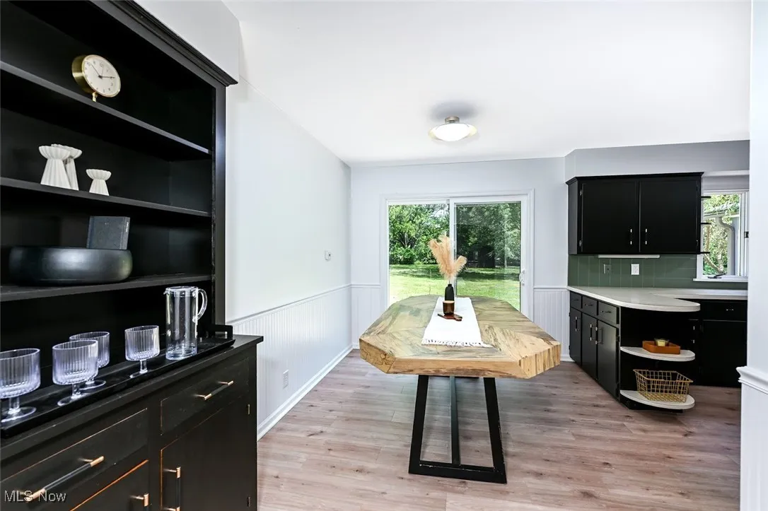 *EAT IN KITCHEN W/BLACK CHINA CABINET, BLACK/GOLD TEXTURED HARDWARE, WAINSCOTING, LUXURY PLANK FLOORING & SLIDERS TO THE BACK PATIO ~