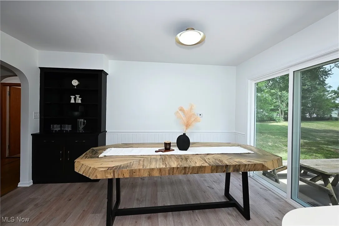 *EAT IN KITCHEN W/BLACK CHINA CABINET, BLACK/GOLD TEXTURED HARDWARE, WAINSCOTING, LUXURY PLANK FLOORING & SLIDERS TO THE BACK PATIO ~