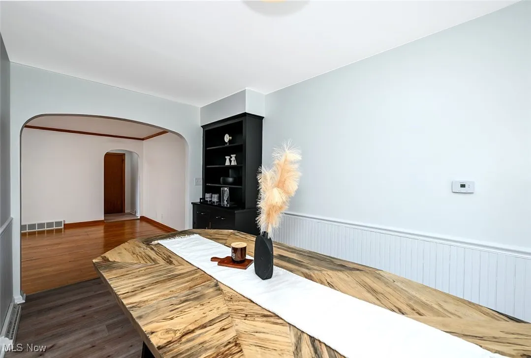 *EAT IN KITCHEN W/BLACK CHINA CABINET, BLACK/GOLD TEXTURED HARDWARE, WAINSCOTING, LUXURY PLANK FLOORING & SLIDERS TO THE BACK PATIO ~