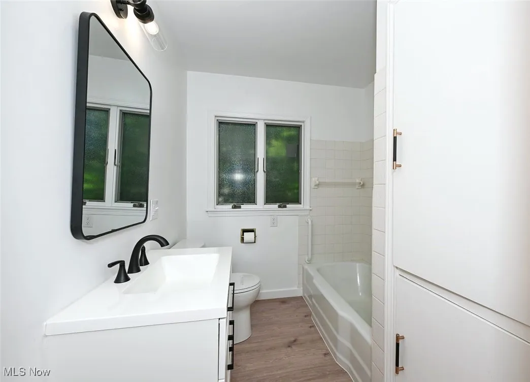 *BATHROOM W/WHITE VANITY, LINEN CLOSET, BLACK ACCENT HARDWARE AND PFISTER FAUCET, MIRROR AND DOUBLE LIGHTING SCONCE, TUB AND SHOWER, LUXURY PLANK FLOORING ~