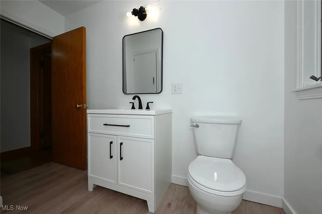 *BATHROOM W/WHITE VANITY, LINEN CLOSET, BLACK ACCENT HARDWARE AND PFISTER FAUCET, MIRROR AND DOUBLE LIGHTING SCONCE, TUB AND SHOWER, LUXURY PLANK FLOORING ~