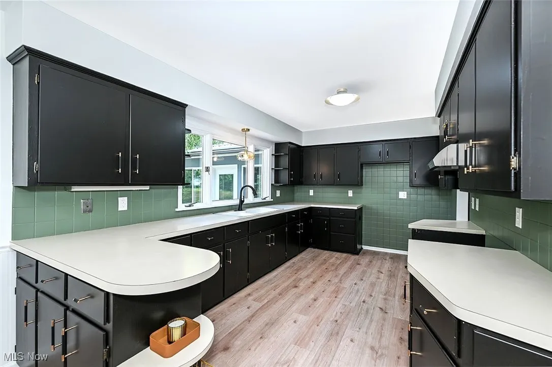 *KITCHEN W/BLACK CABINETS, BLACK/GOLD TEXTURED HARDWARE, PENINISULA W/DOUBLE SIDED CABINETS, ABOVE SINK PENDANT LIGHTING AND LUXURY PLANK FLOORING ~