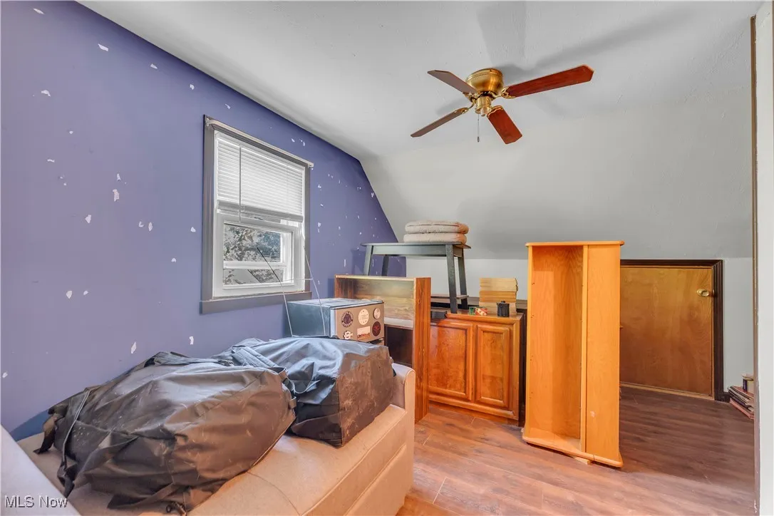 Bedroom with wood finished floors and vaulted ceiling
