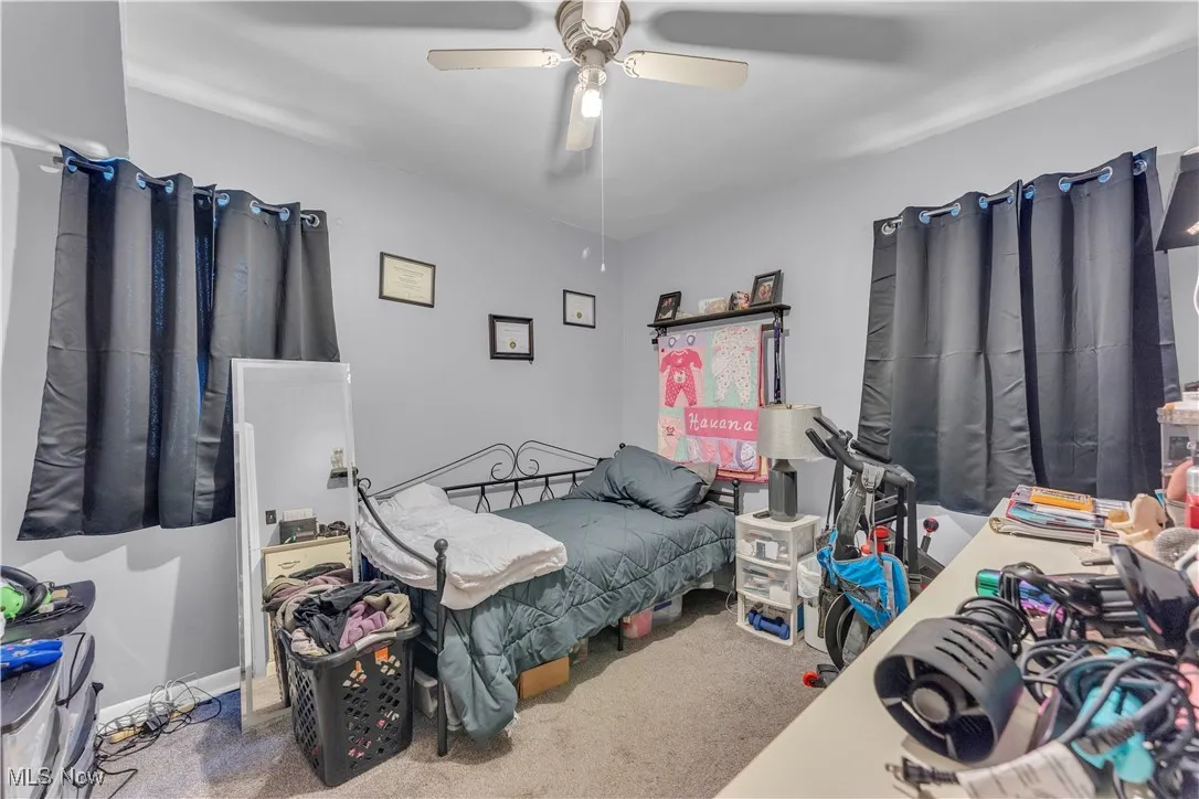 Bedroom with light colored carpet and baseboards
