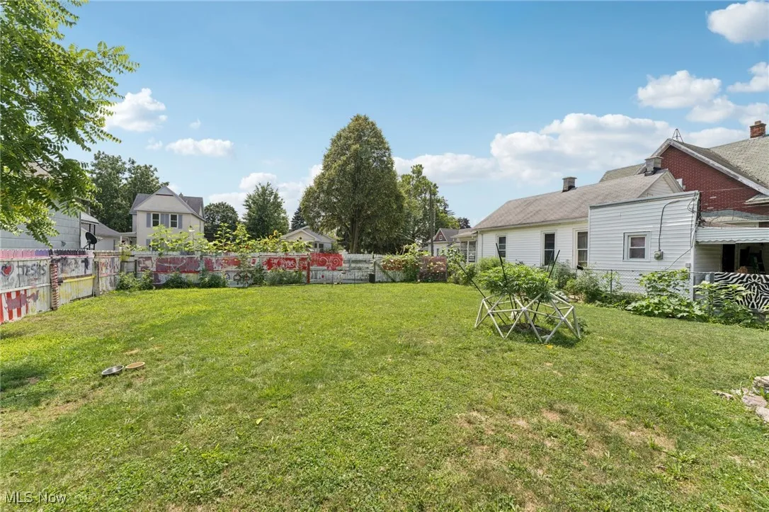 Fenced backyard with a residential view