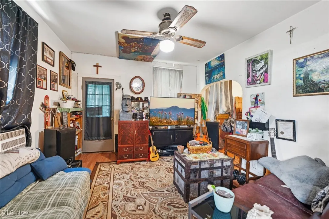 Living room with wood finished floors and ceiling fan