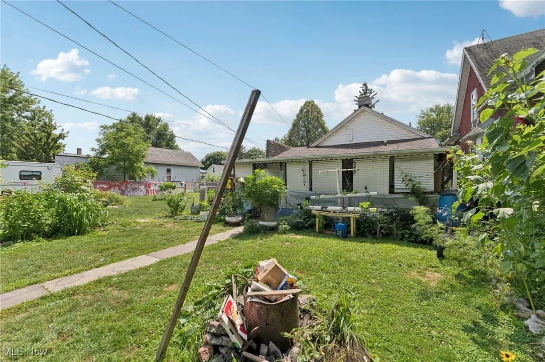 Rear view of property with a yard