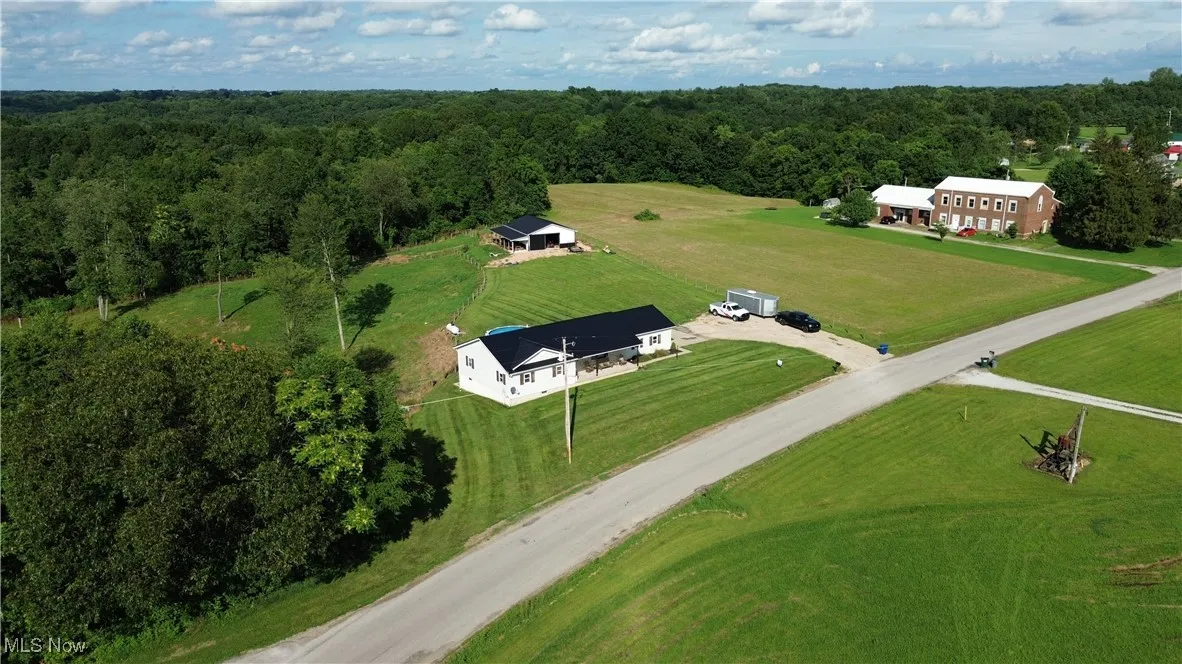 Overview of rural landscape featuring a heavily wooded area