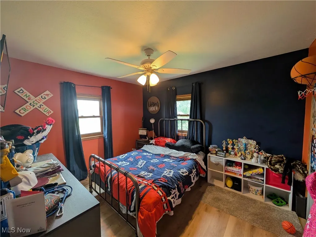 Bedroom featuring wood finished floors and a ceiling fan