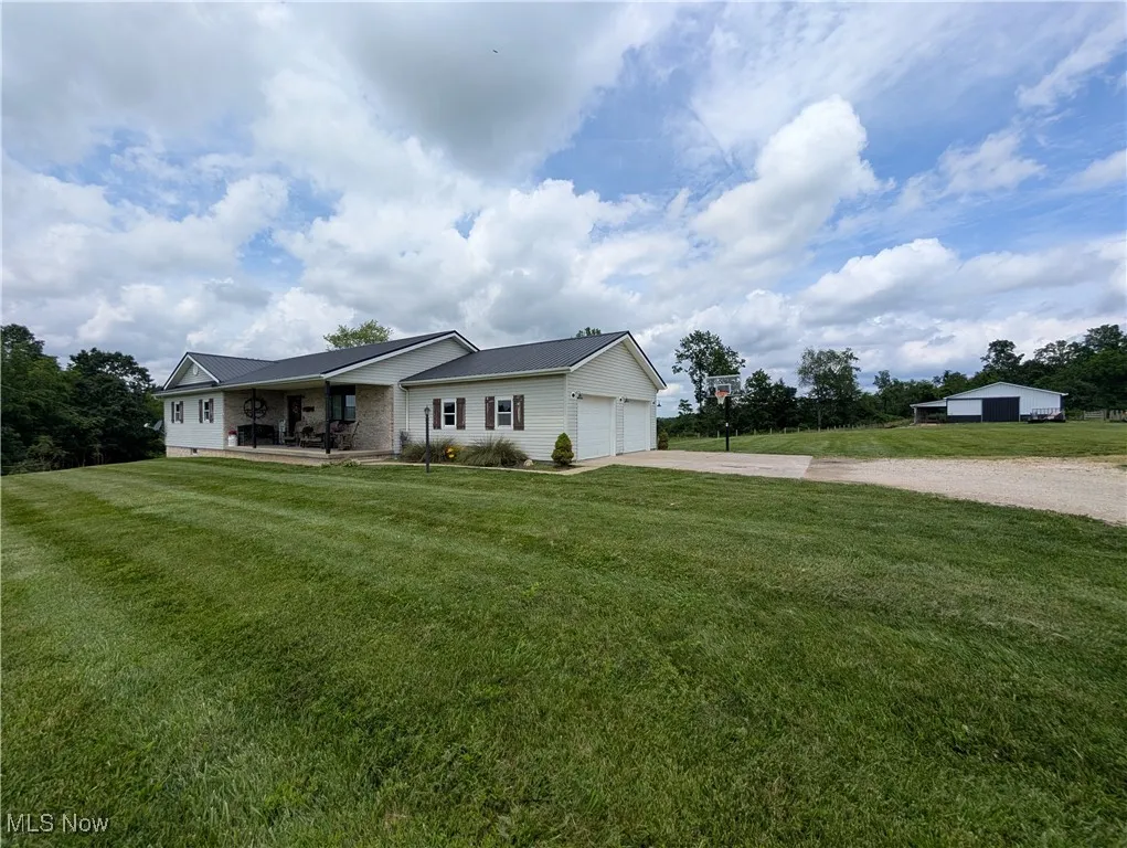 Single story home featuring concrete driveway, a garage, and a front yard