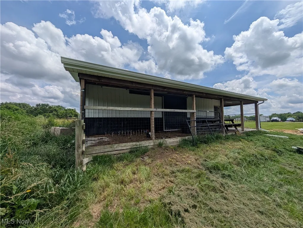 View of outbuilding with an exterior structure