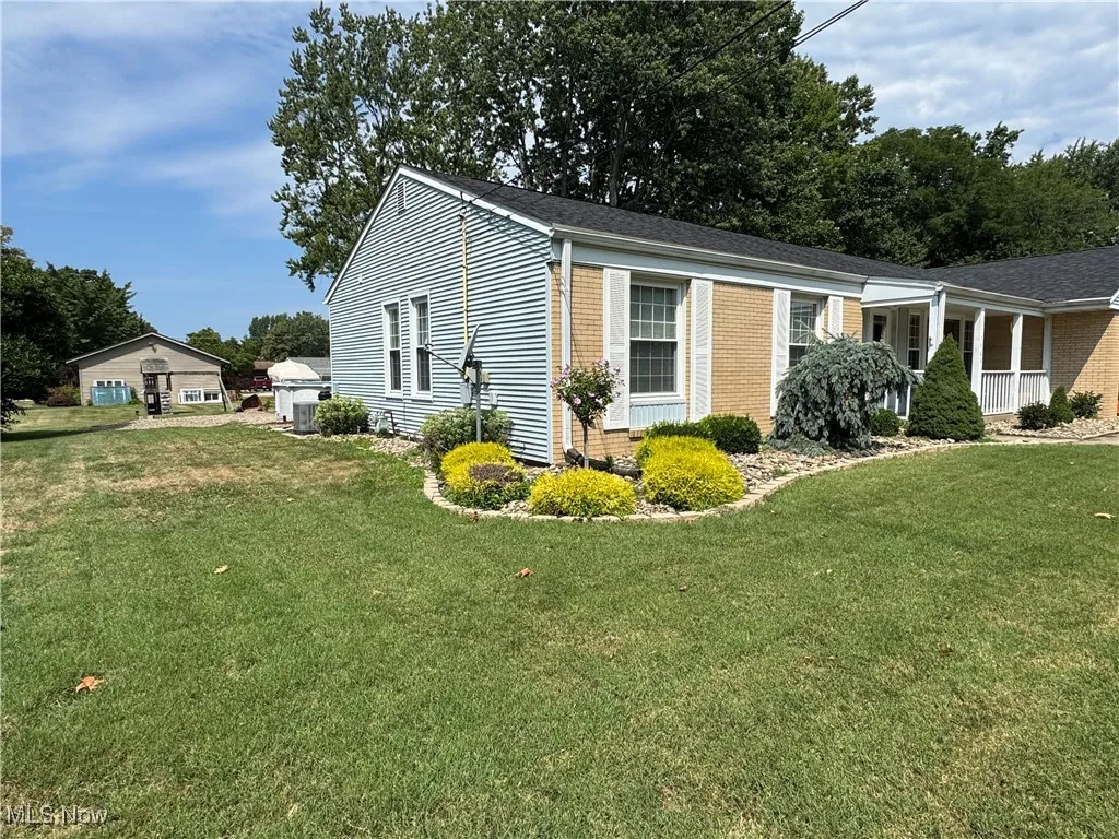 View of front of home featuring a front yard and brick siding