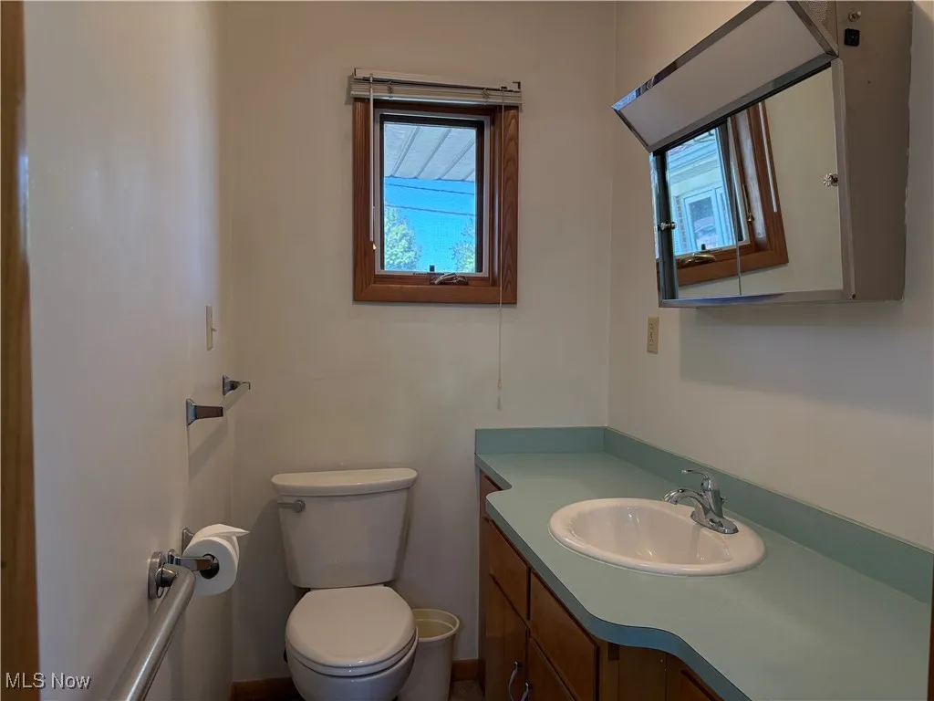 Half bath featuring toilet and vanity