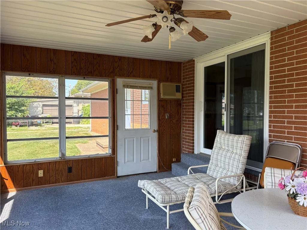 Sunroom featuring ceiling fan