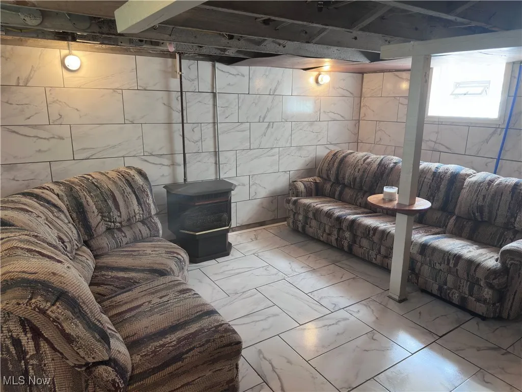 Living room with marble look tiles and tile walls