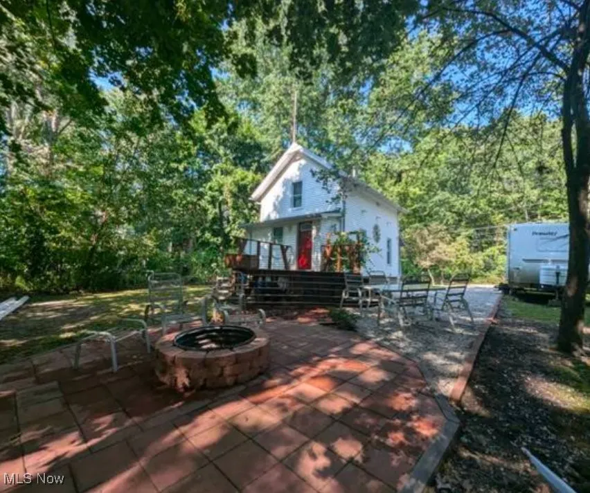 View of patio featuring a fire pit and a wooden deck