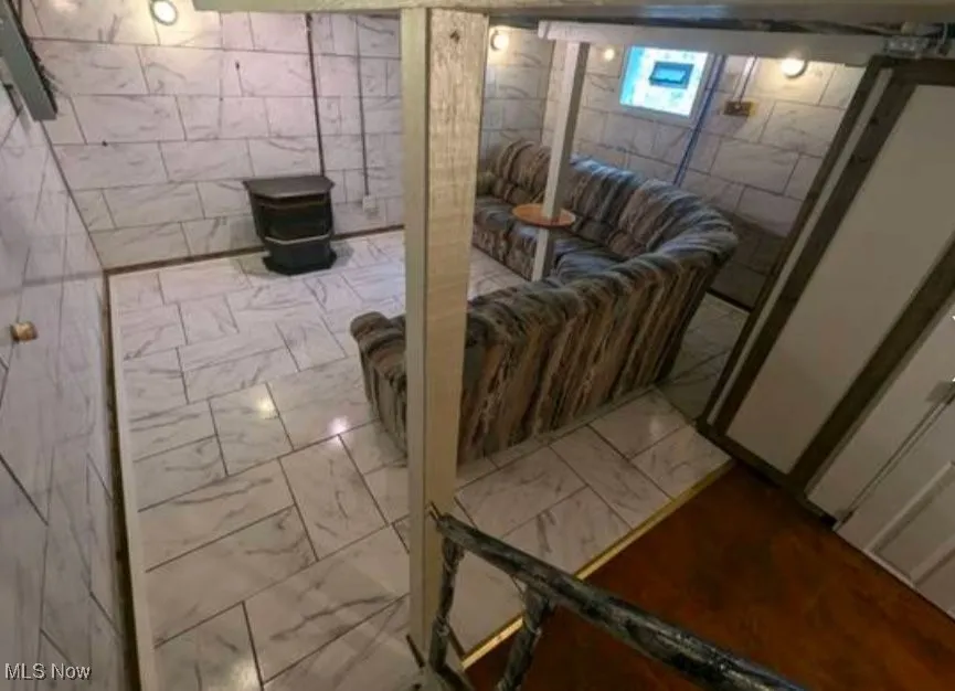 Below grade area featuring marble look tile flooring