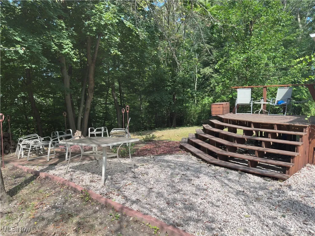 View of yard with a wooden deck