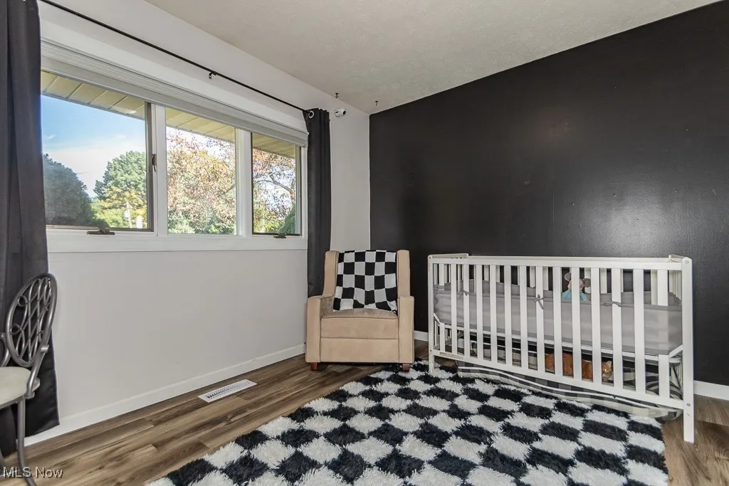 Bedroom featuring baseboards and wood finished floors
