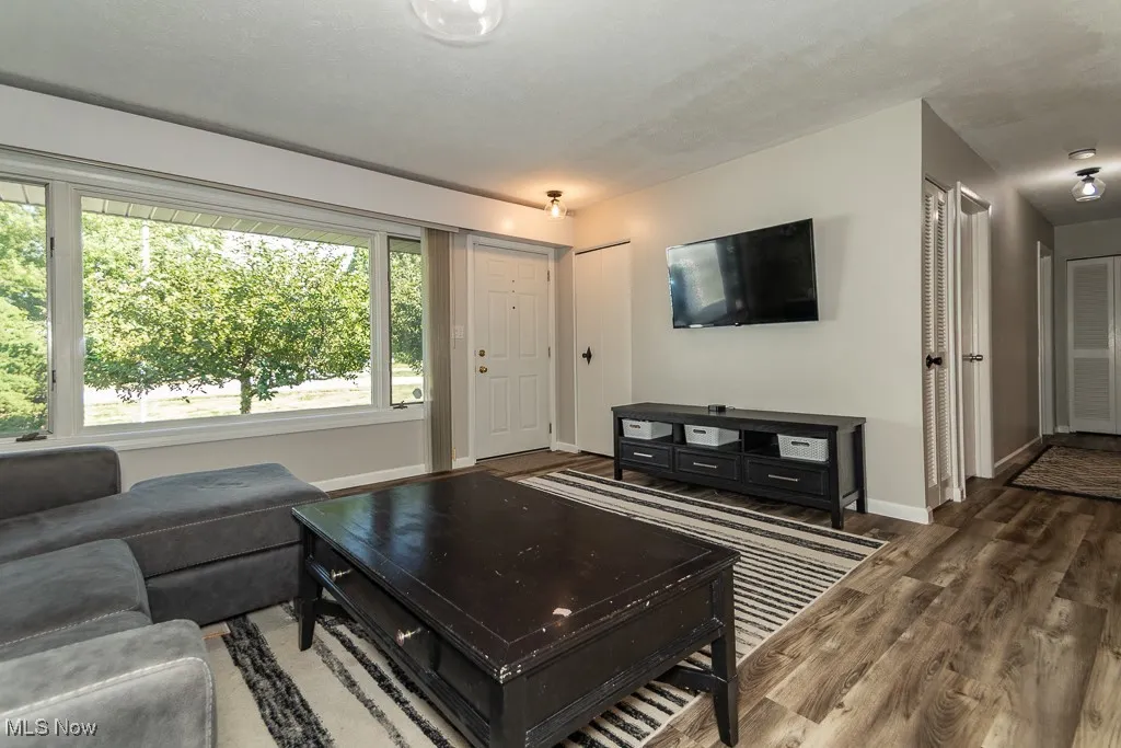 Living room featuring wood finished floors and baseboards