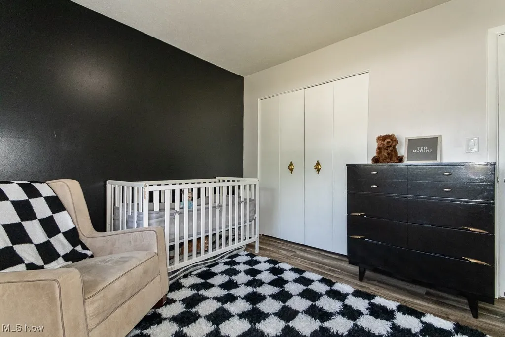 Bedroom featuring wood finished floors and a closet