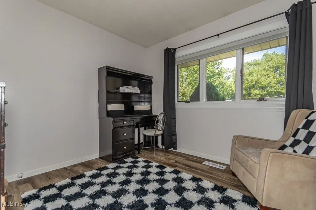 Office with wood finished floors and baseboards