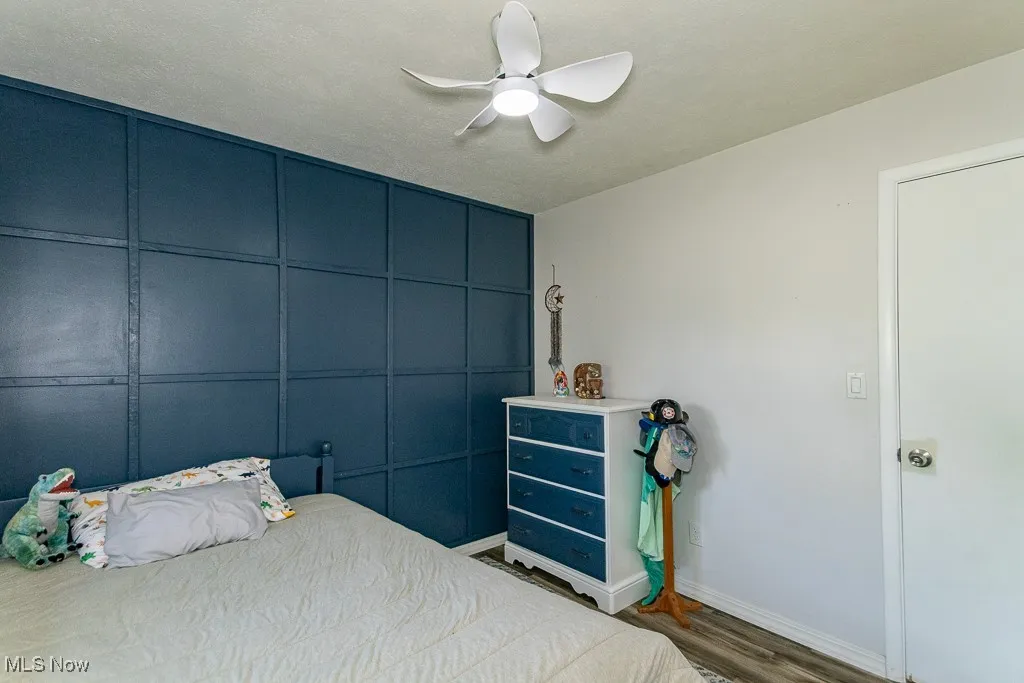Bedroom with wood finished floors and ceiling fan