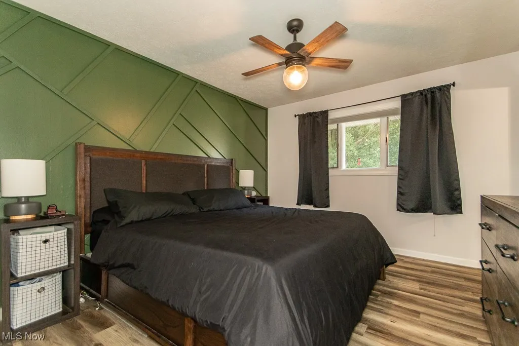 Bedroom with wood finished floors and a ceiling fan