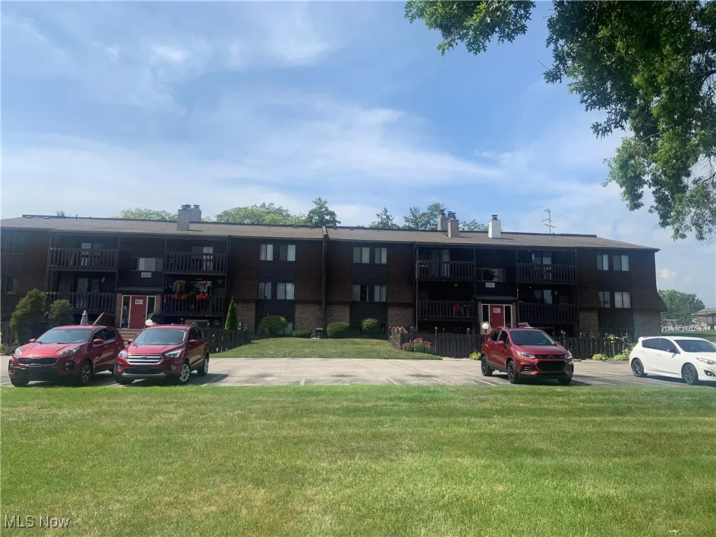 View of property with uncovered parking