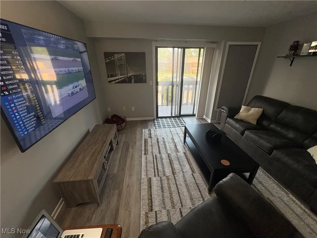 Living room featuring wood finished floors and baseboards