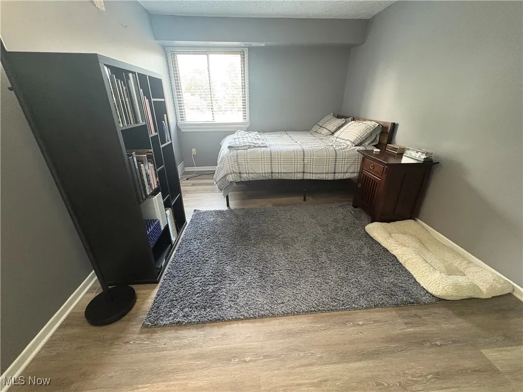 Bedroom featuring wood finished floors and a textured ceiling