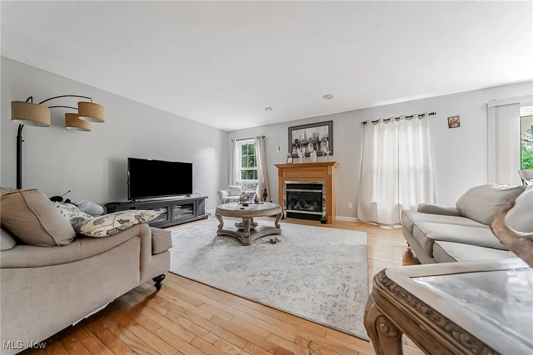 Living area with light wood finished floors and a fireplace with flush hearth