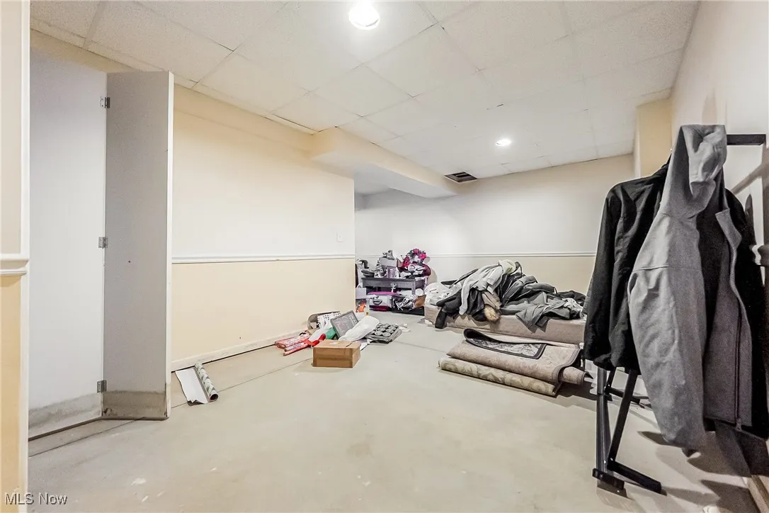 Exercise room featuring a drop ceiling and recessed lighting