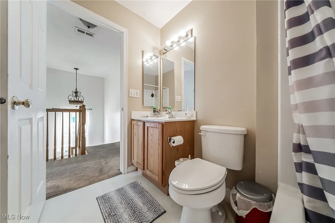 Full bathroom with vanity and a shower with shower curtain