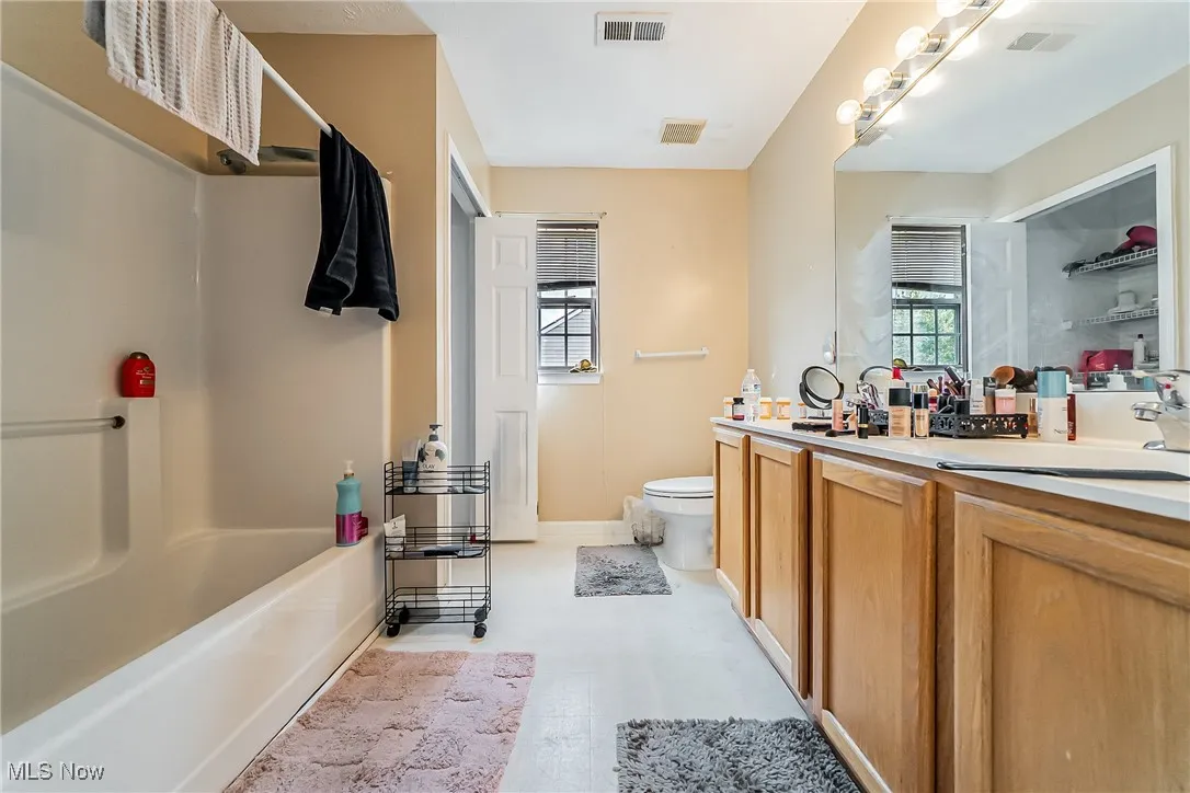 Bathroom featuring vanity and shower / bathtub combination