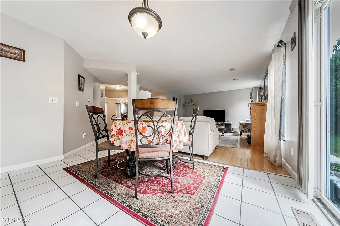 Dining room with light tile patterned floors and baseboards