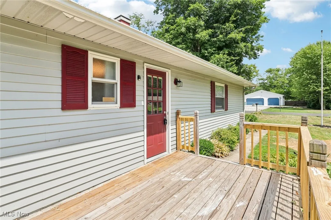 Wooden deck featuring a garage