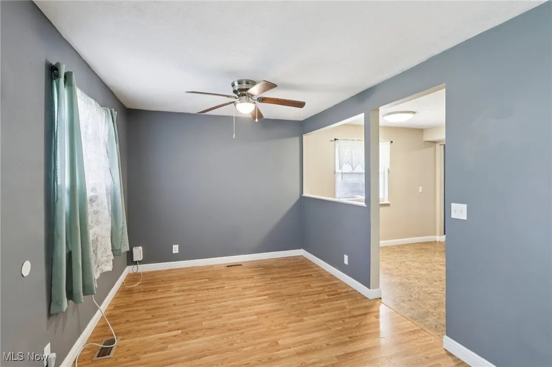 Unfurnished room featuring wood finished floors and ceiling fan