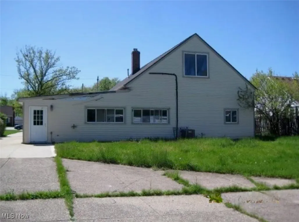 Rear view of property with a chimney