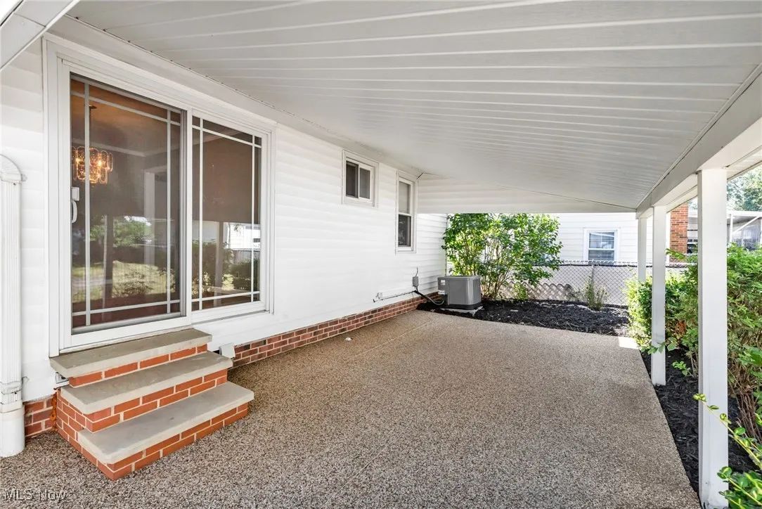 View of patio featuring entry steps and an attached carport