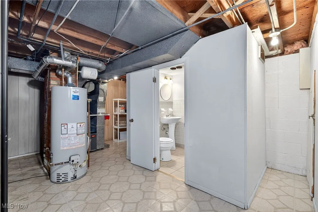 Basement featuring light floors, gas water heater, and heating​​‌​​​​‌​​‌‌​‌‌​​​‌‌​‌​‌​‌​​​‌​​ unit