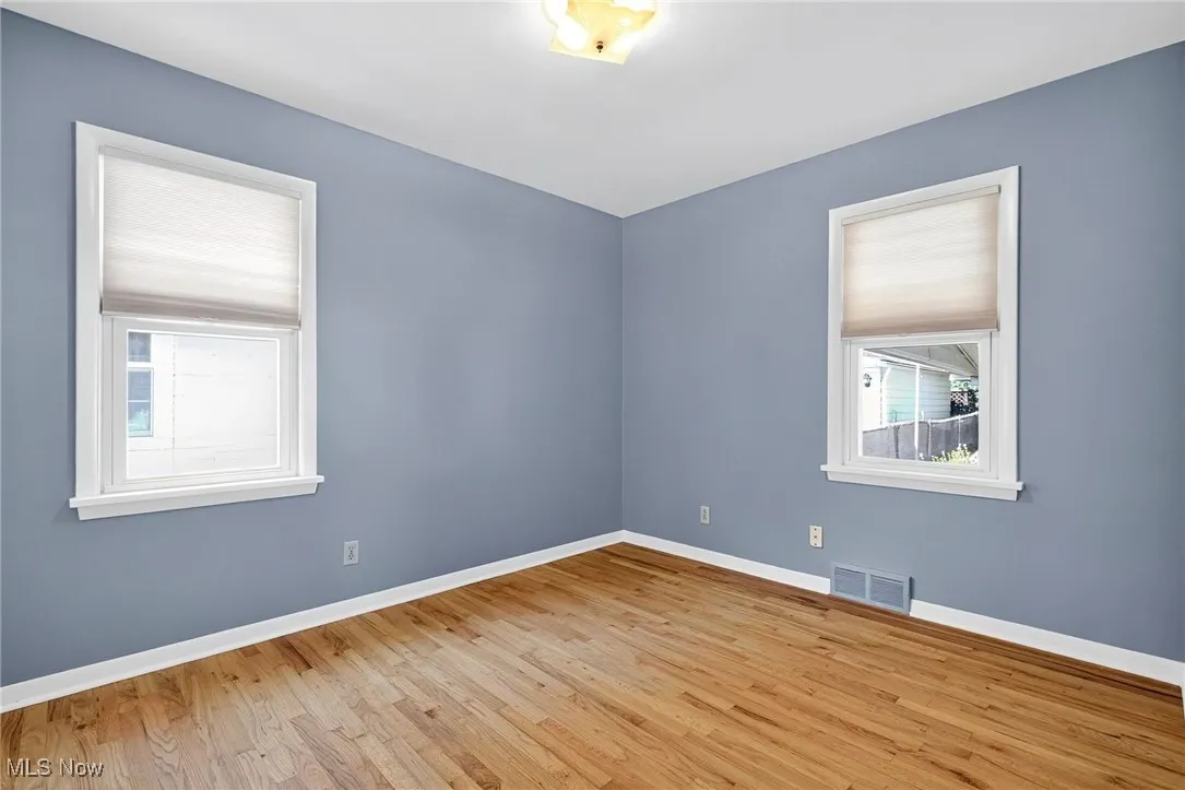 Empty room with wood finished floors and baseboards