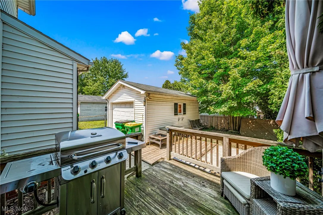 Deck featuring an outdoor structure, grilling area, and a garage
